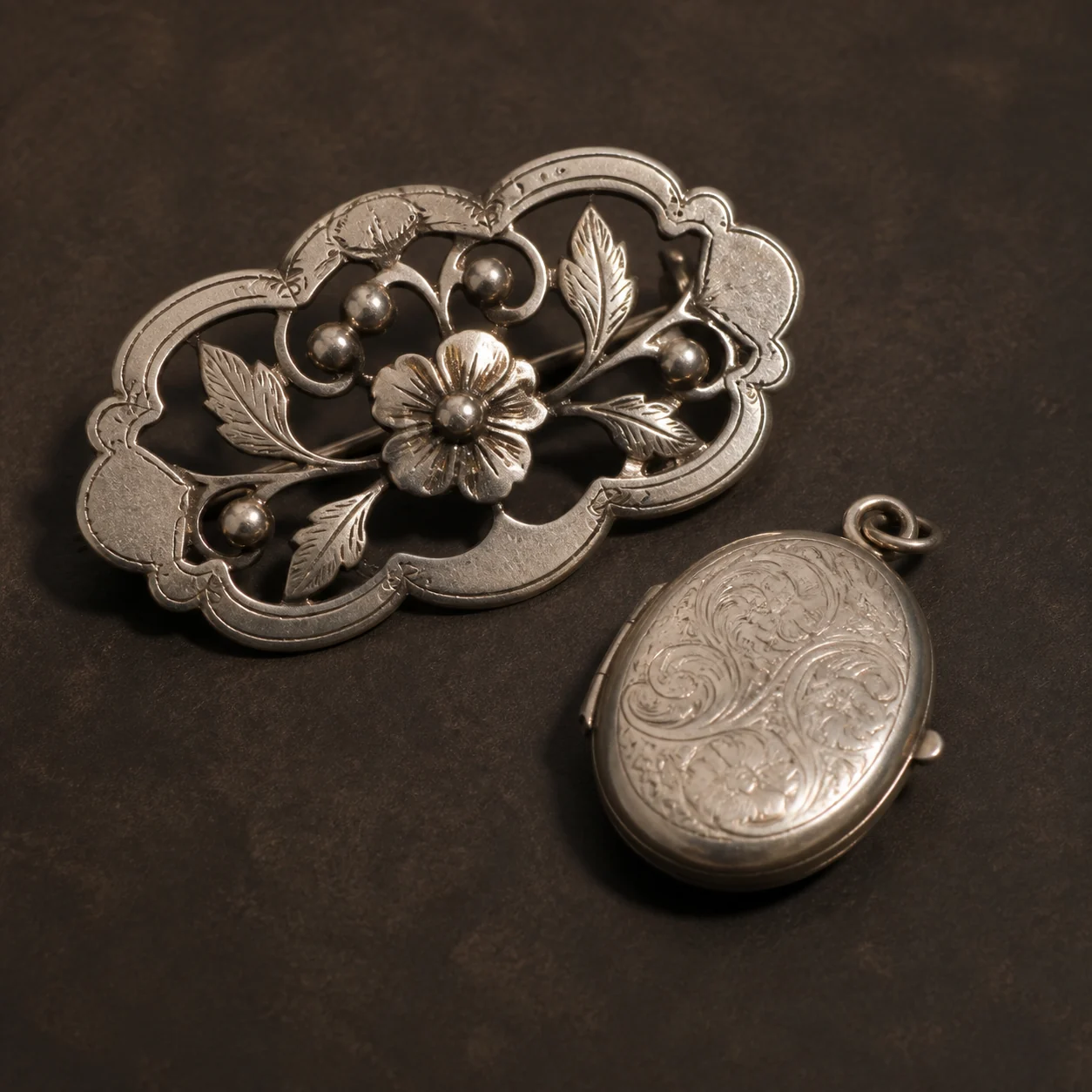 Sample antique silver brooch and locket for hallmark identification